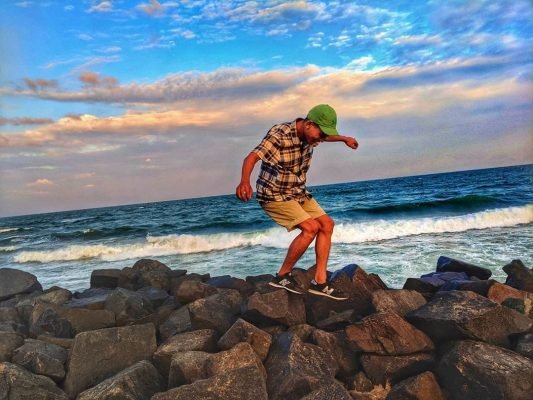 boy showing his great moves on the beach rock