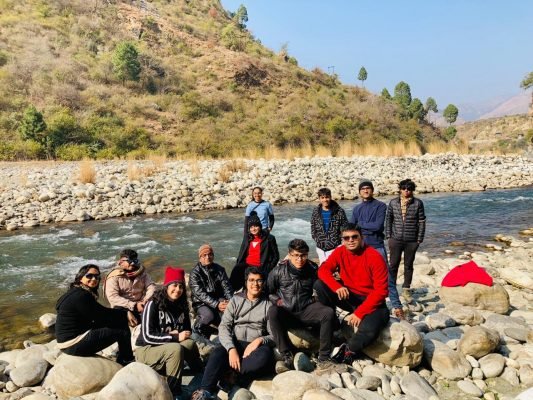 Group Posing Next To River | Kedarkantha Trek- Hikerwolf